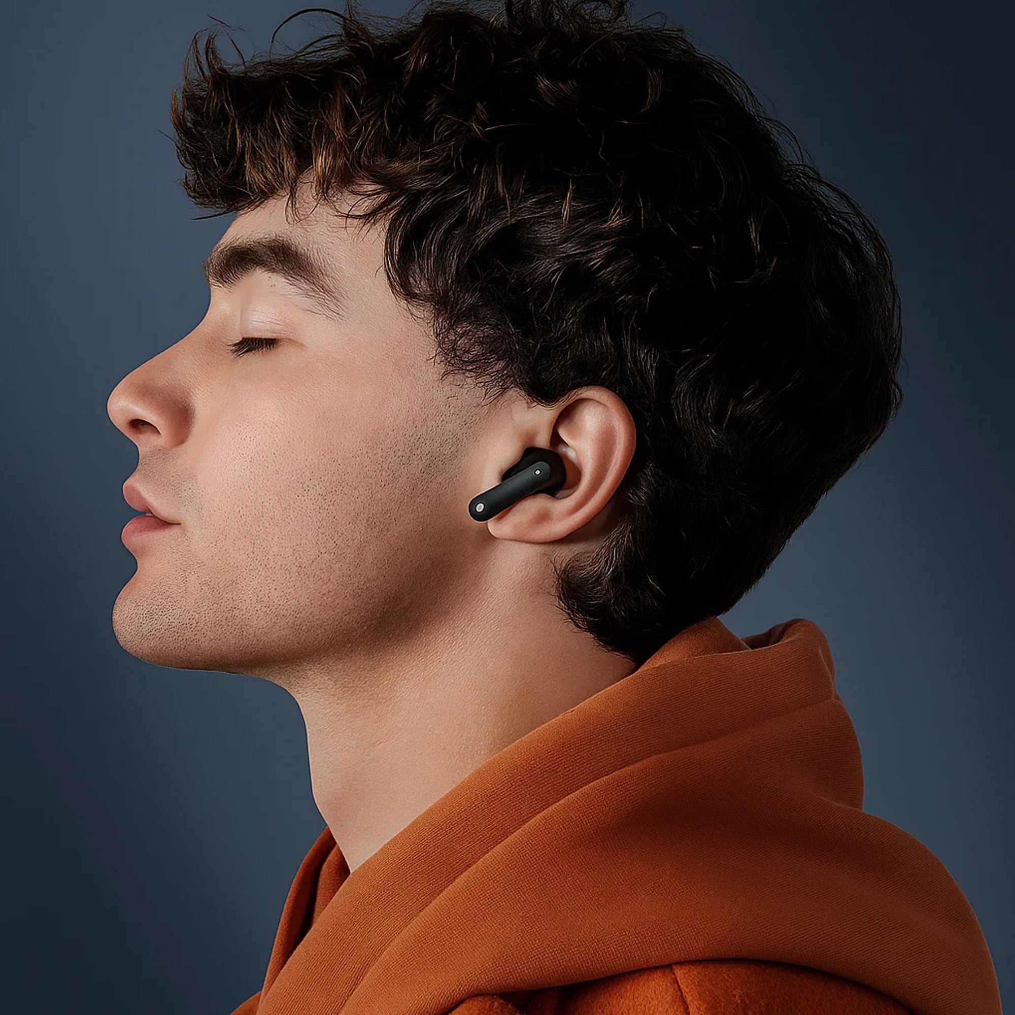 User wearing CTRL8 CMT Ultra Pro noise-cancelling Bluetooth earbuds in black for immersive audio experience