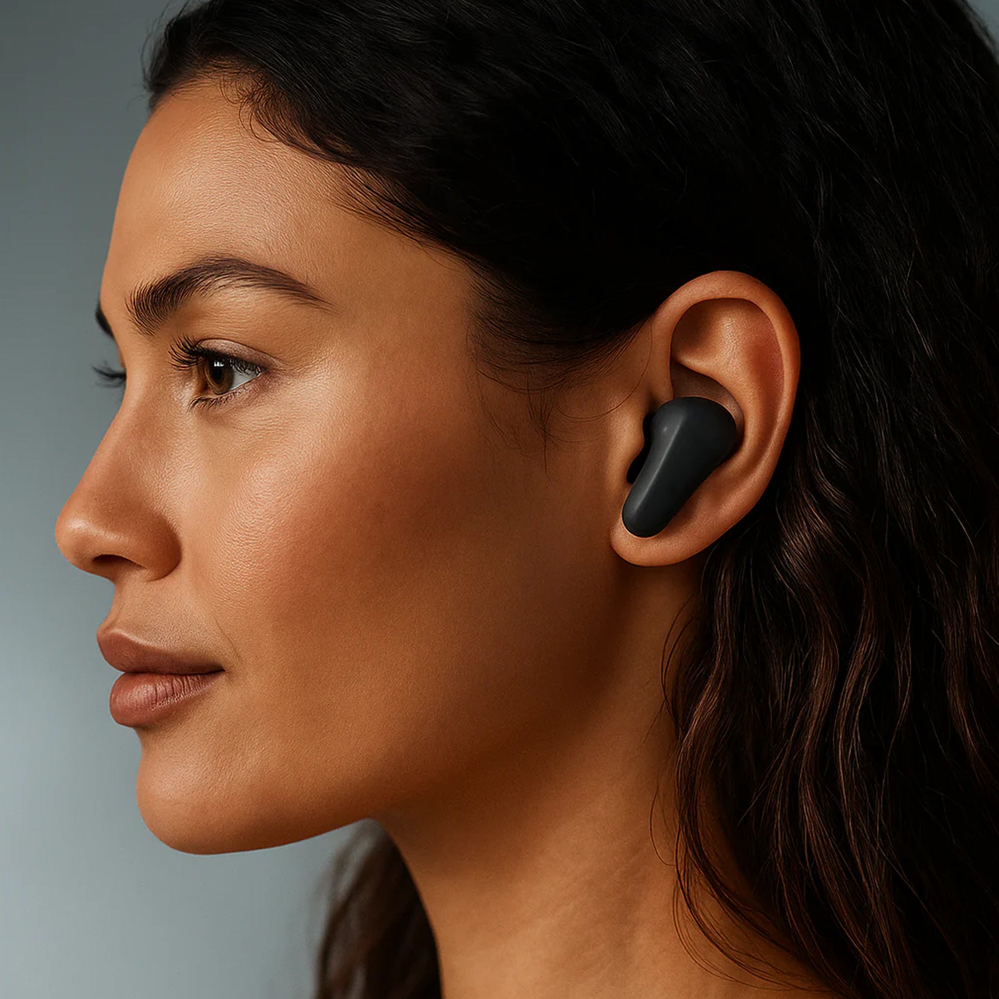 Close-up of user wearing CTRL8 CMT Ultra Pro noise-cancelling Bluetooth earbuds in black for clear sound